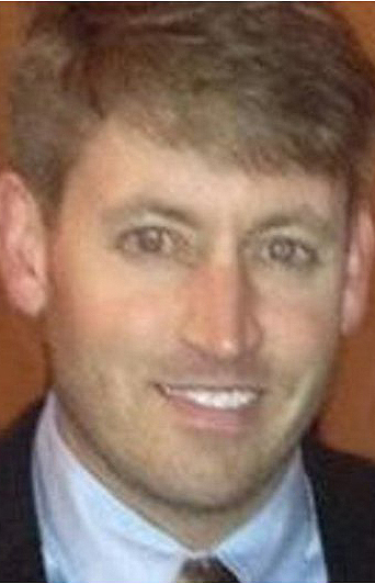 Headshot of a man wearing a suit.