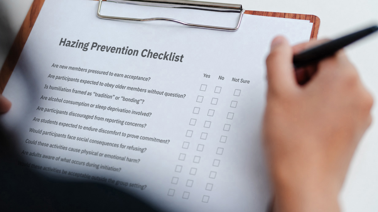 A person holds a clipboard holding a survey about perceptions of hazing.