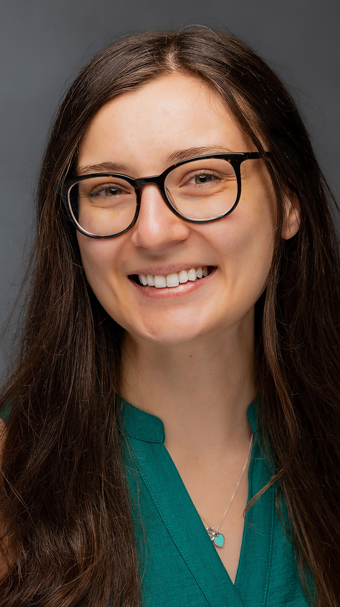 Headshot of a woman wearing a green blouse.