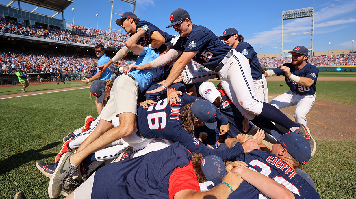 Baseball players celebrate a victory by forming a dogpile on the field.