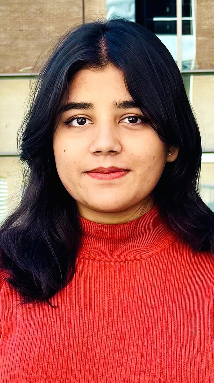 Headshot of a woman wearing a red sweater.