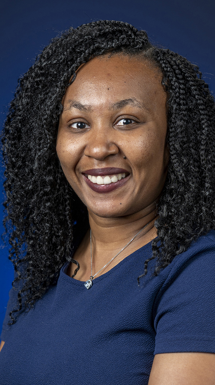 Headshot of a woman wearing a dark blue blouse.