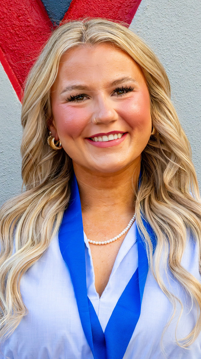 Photo of a young women wearing a dark blue ribbon around her neck.