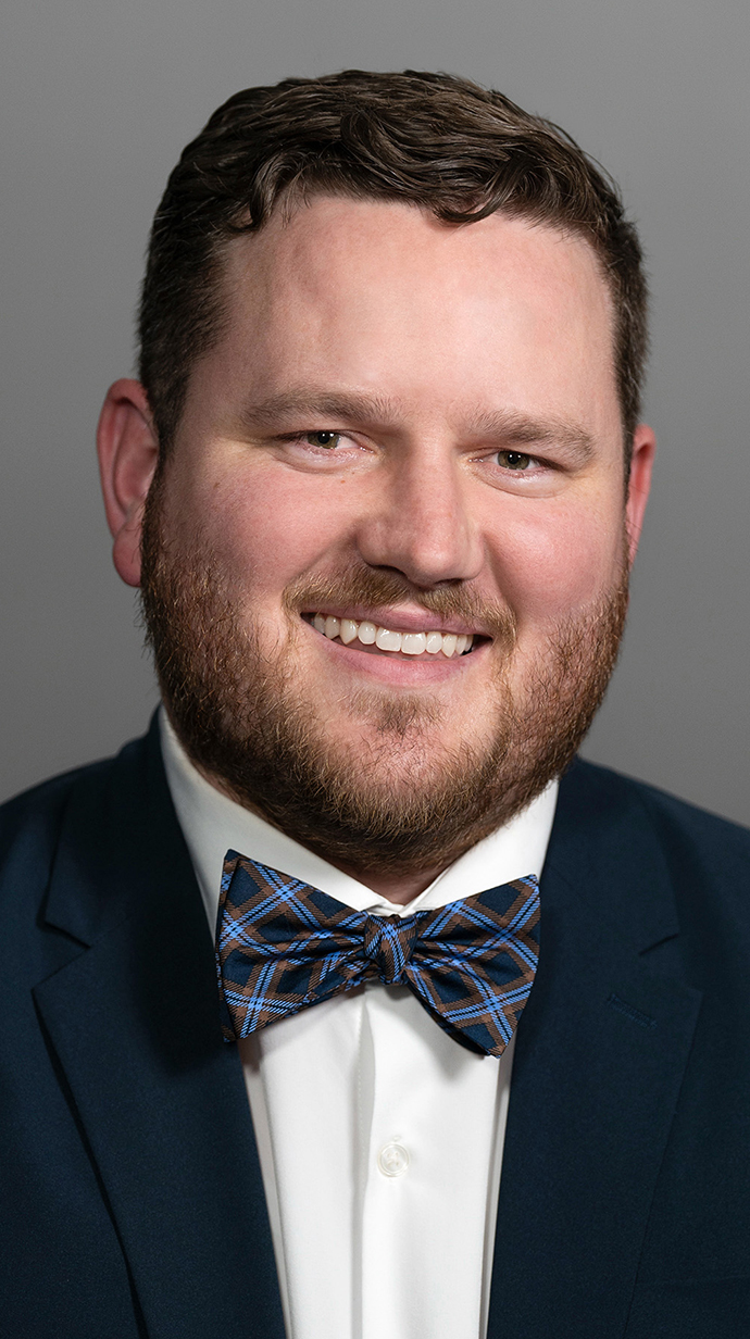 Headshot of a man wearing a dark suite with a bowtie.