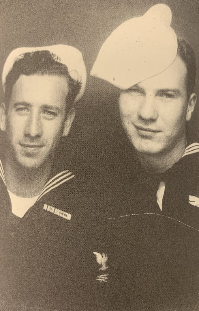 Vintage photo of two men wearing Navy sailor's uniforms.