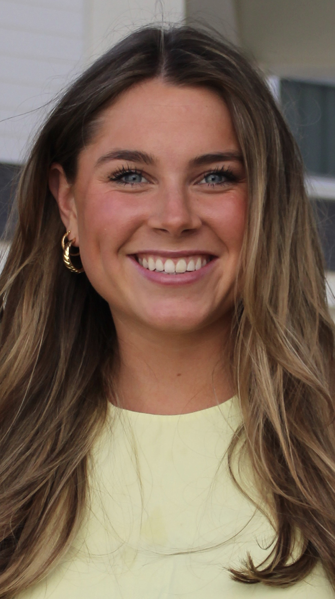 Headshot of a young woman wearing a pale yellow dress.