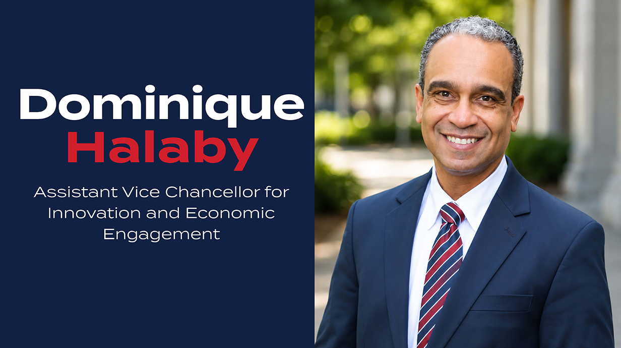 Headshot of a man wearing a dark suit with type beside it reading 'Dominique Halaby: Assistant Vice Chancellor for Innovation and Economic Engagement.'
