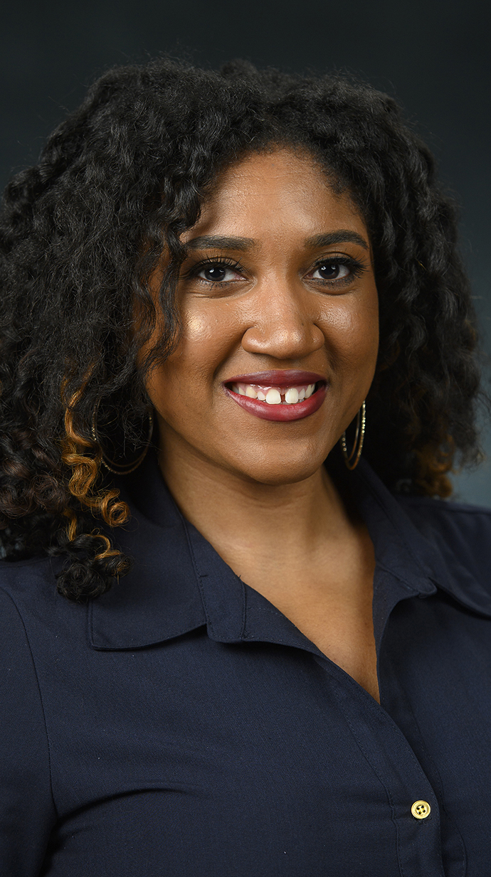 Headshot of a woman wearing a dark blouse.