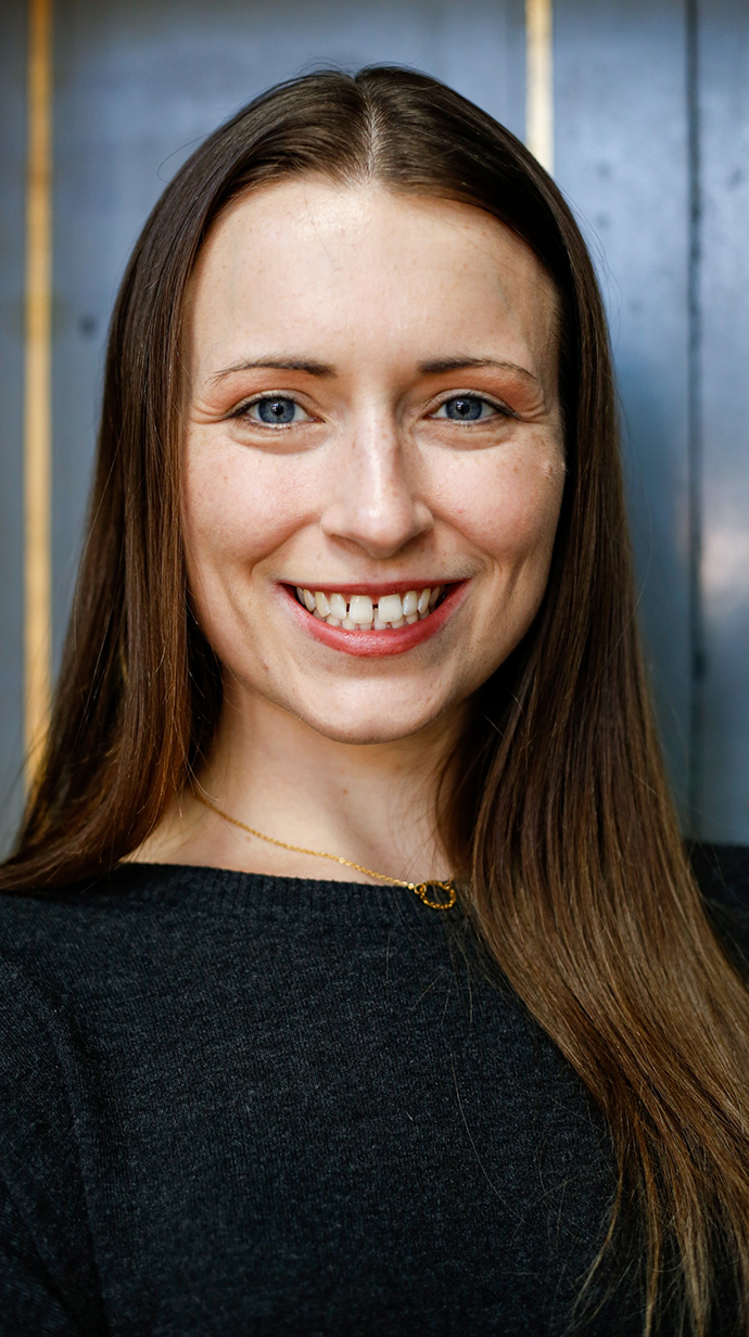 Headshot of a woman wearing a dark blouse.