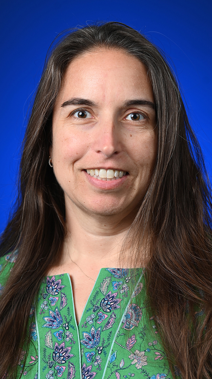 Headshot of a woman wearing a green blouse.
