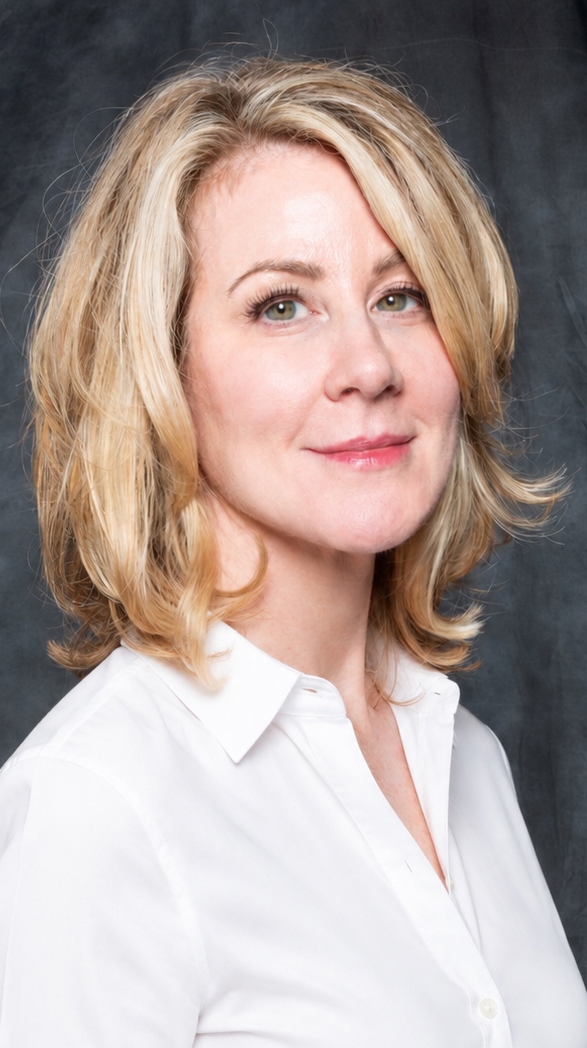 Headshot of a woman wearing a white blouse.