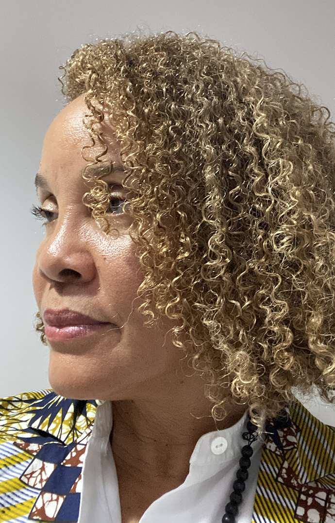 Headshot of a woman looking out of the frame to the left.