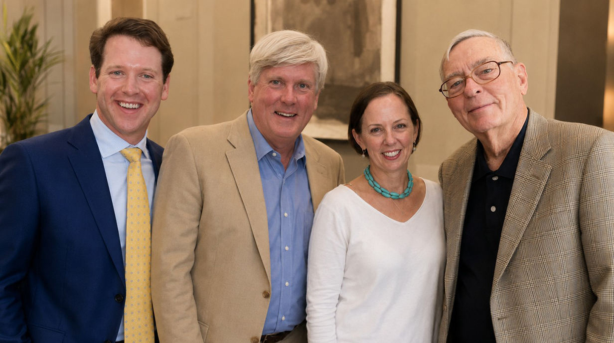 Three men and a woman gather for a family photo.