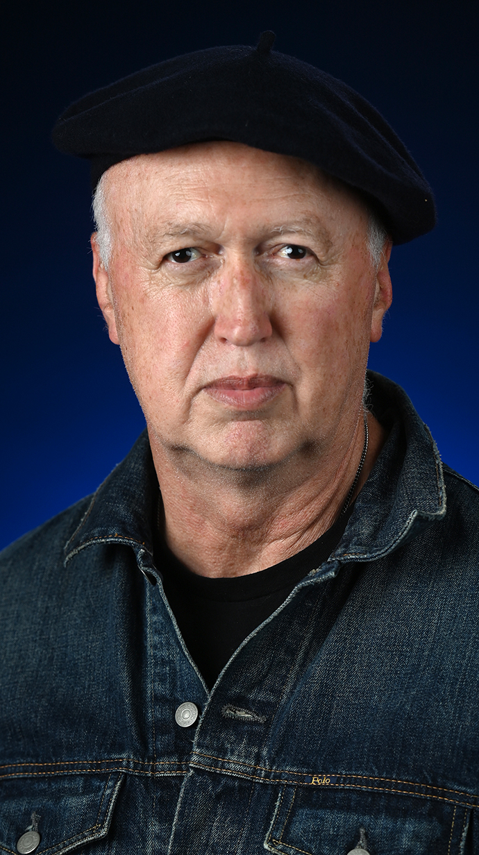 Heaadshot of a man wearing  a black beret.