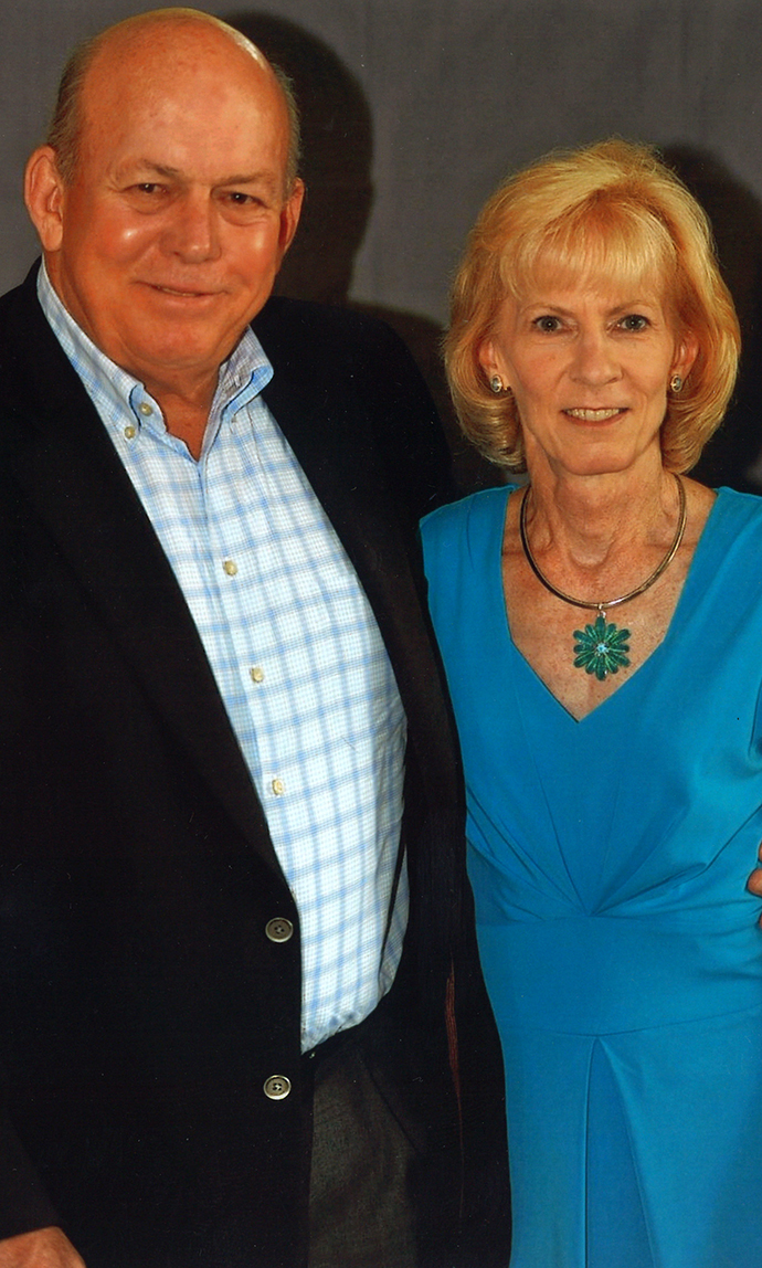 A man and a woman pose for a photo together.
