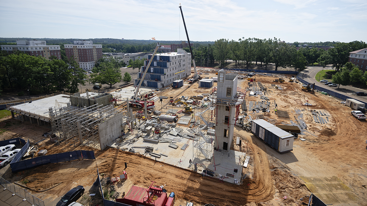 Several large building are being built at a construction site.