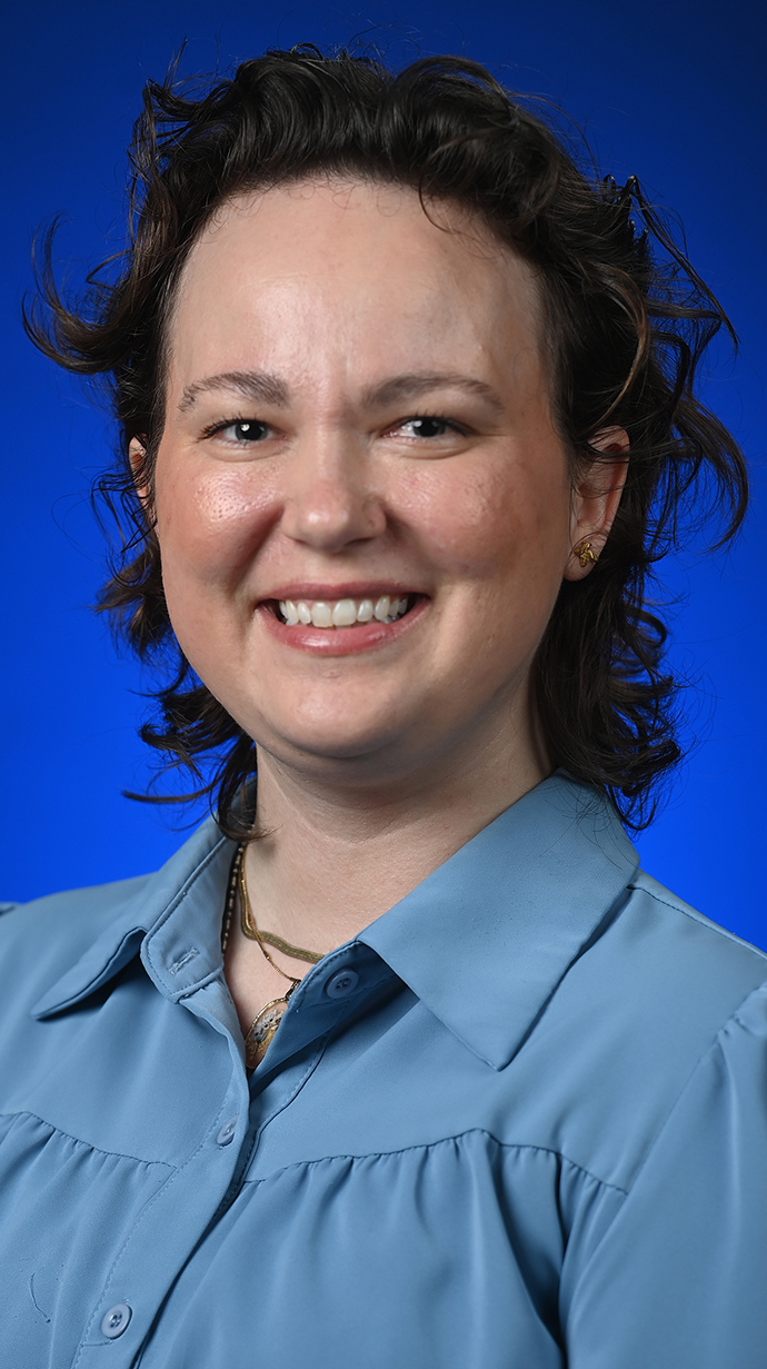 Headshot of a woman wearing a light blue shirt.