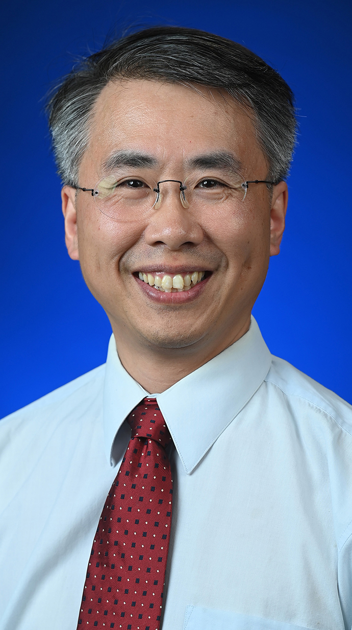 Headshot of a man wearing a white dress shirt with a red tie.