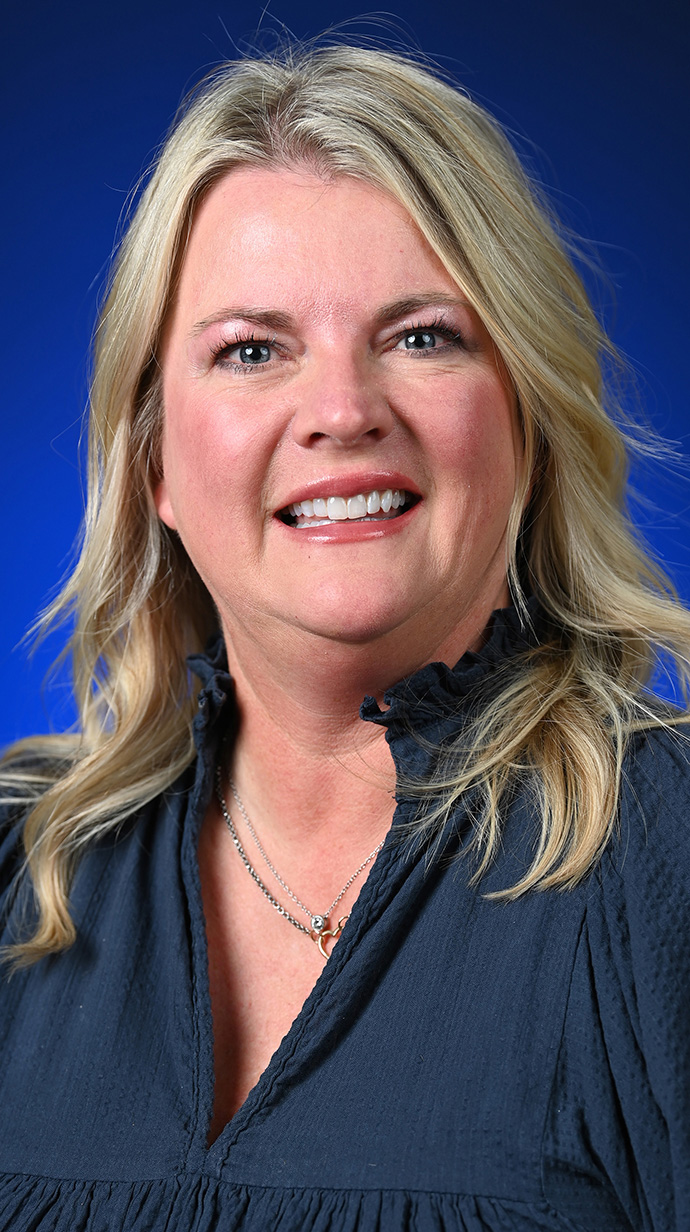 Headshot of a woman wearing a dark shirt.