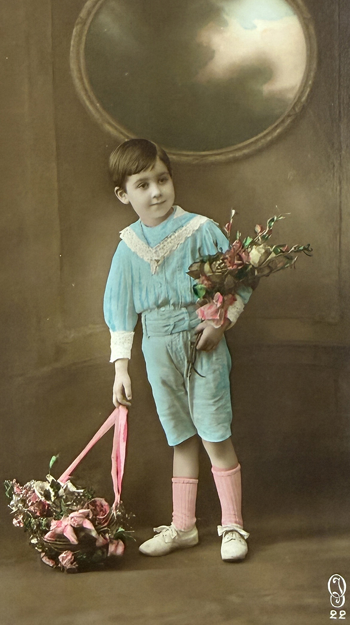 A colorized photo of a young boy holding a bouquet of flowers.