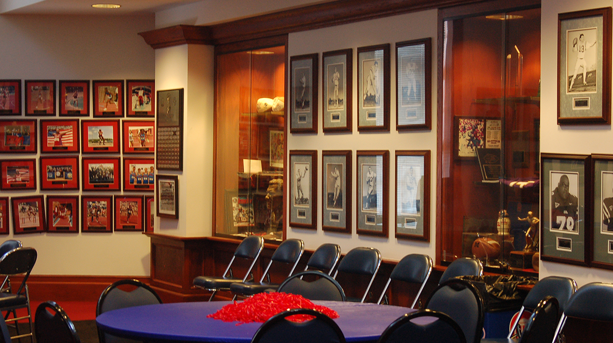 The walls of a banquet room are lined with framed photographs and awards.