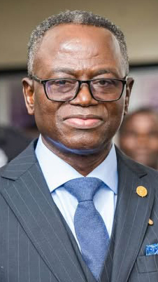 Headshot of a man wearing a gray suit with a blue tie.