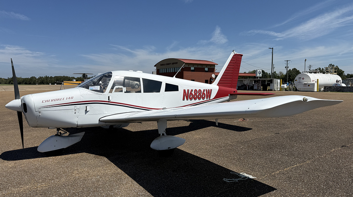 A small airplane sits on an airport tarmac.