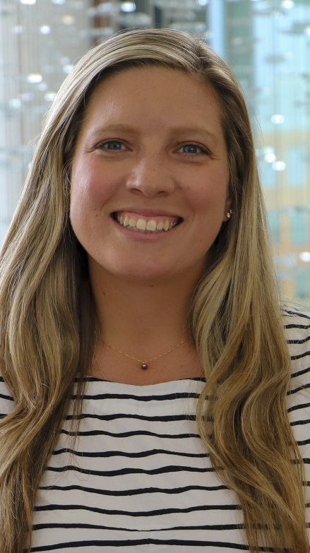 Headshot of a woman wearing a back-and-white striped blouse.