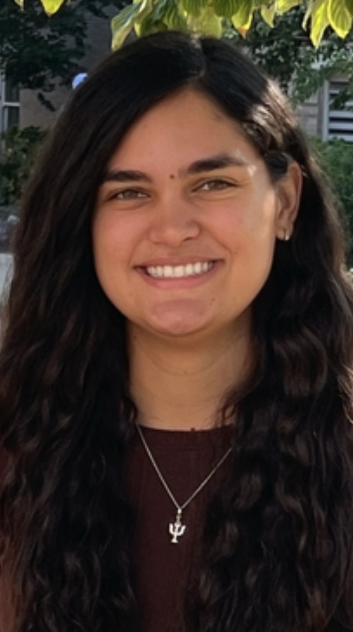Headshot of a young woman wearing a brown sweater.