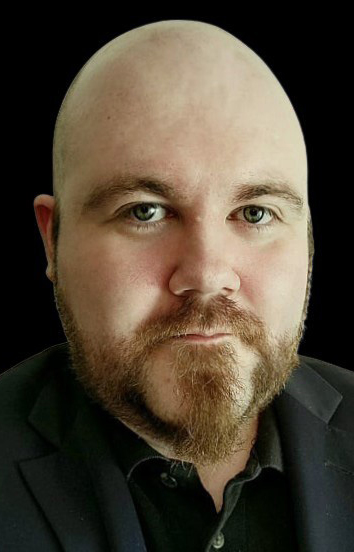 Headshot of a bald man wearing a black shirt.