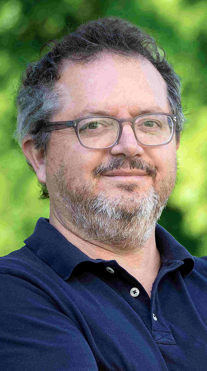 Headshot of a man wearing a dark blue polo shirt.