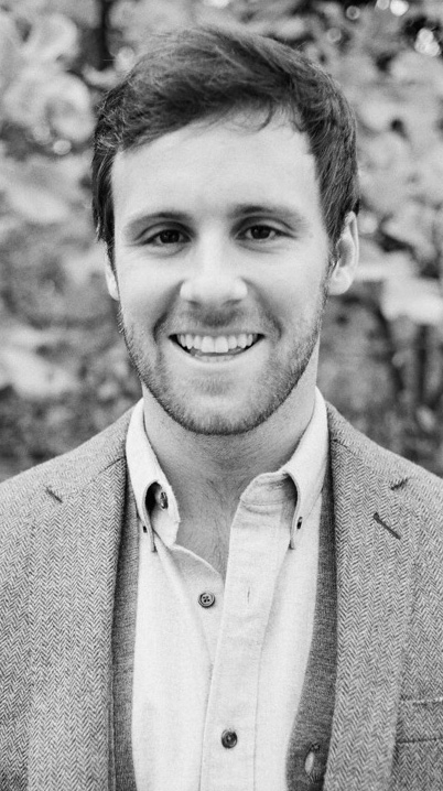 Black-and-white photo of a young man wearing a sport coat.