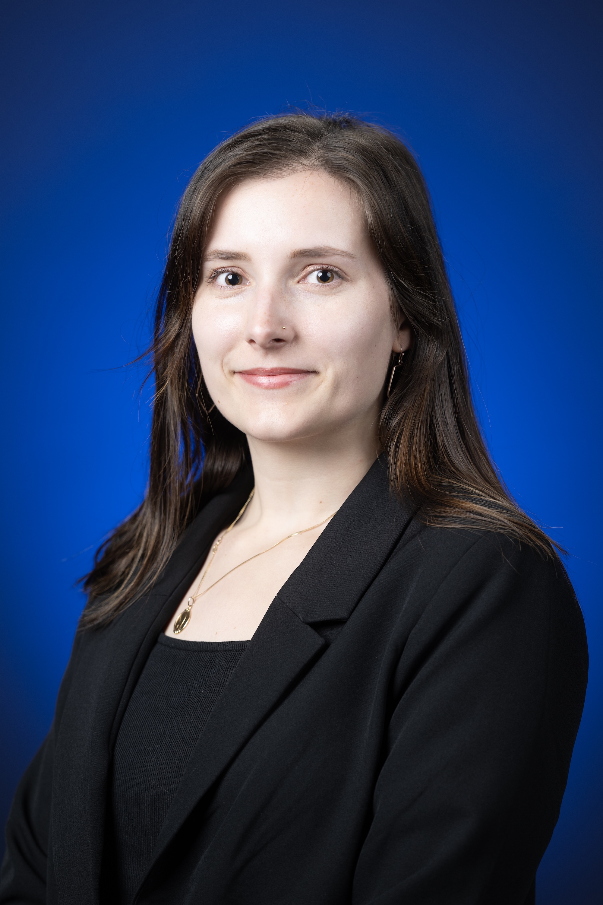 Justine Perrier portrait on blue backdrop