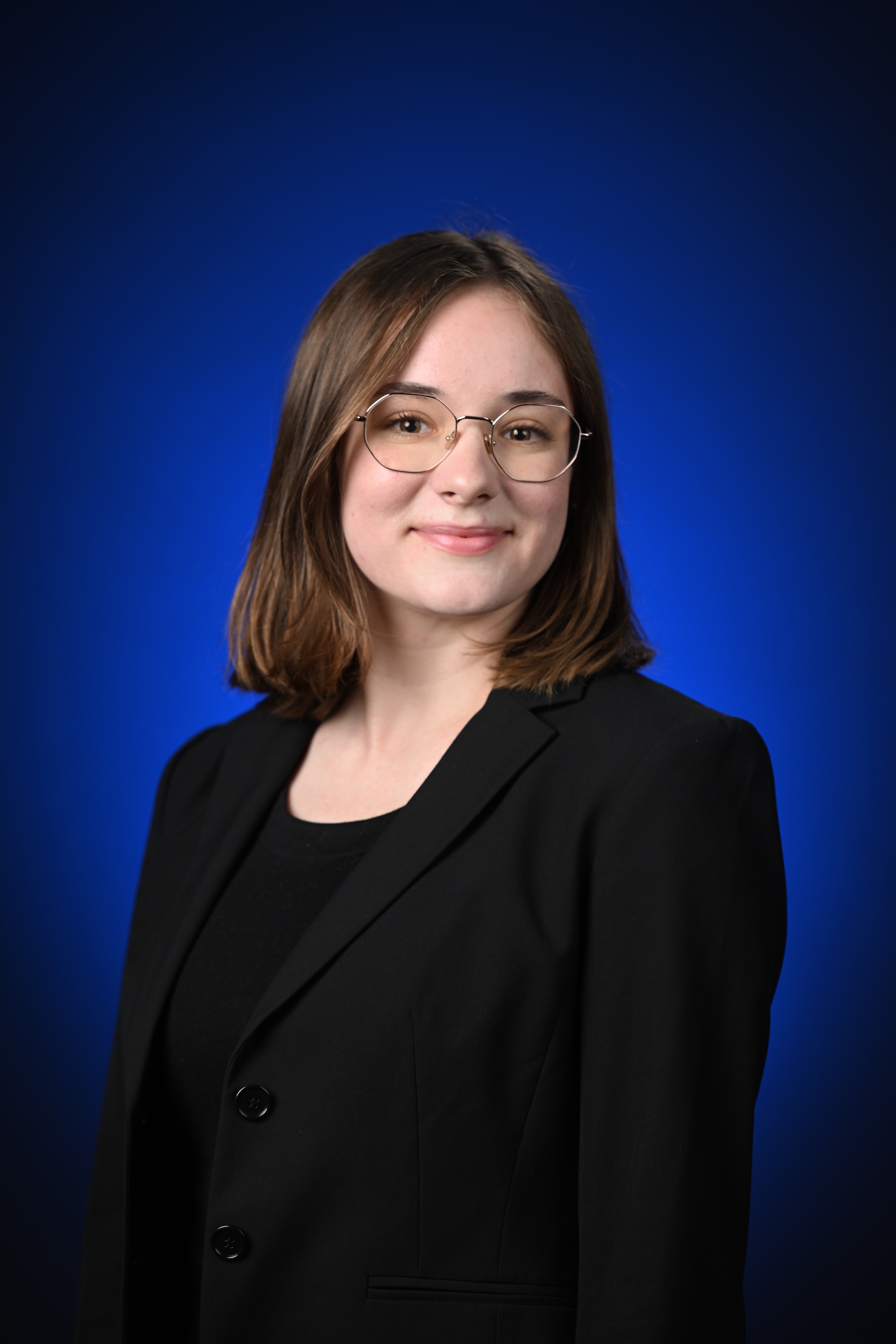 Olivia George portrait on blue backdrop
