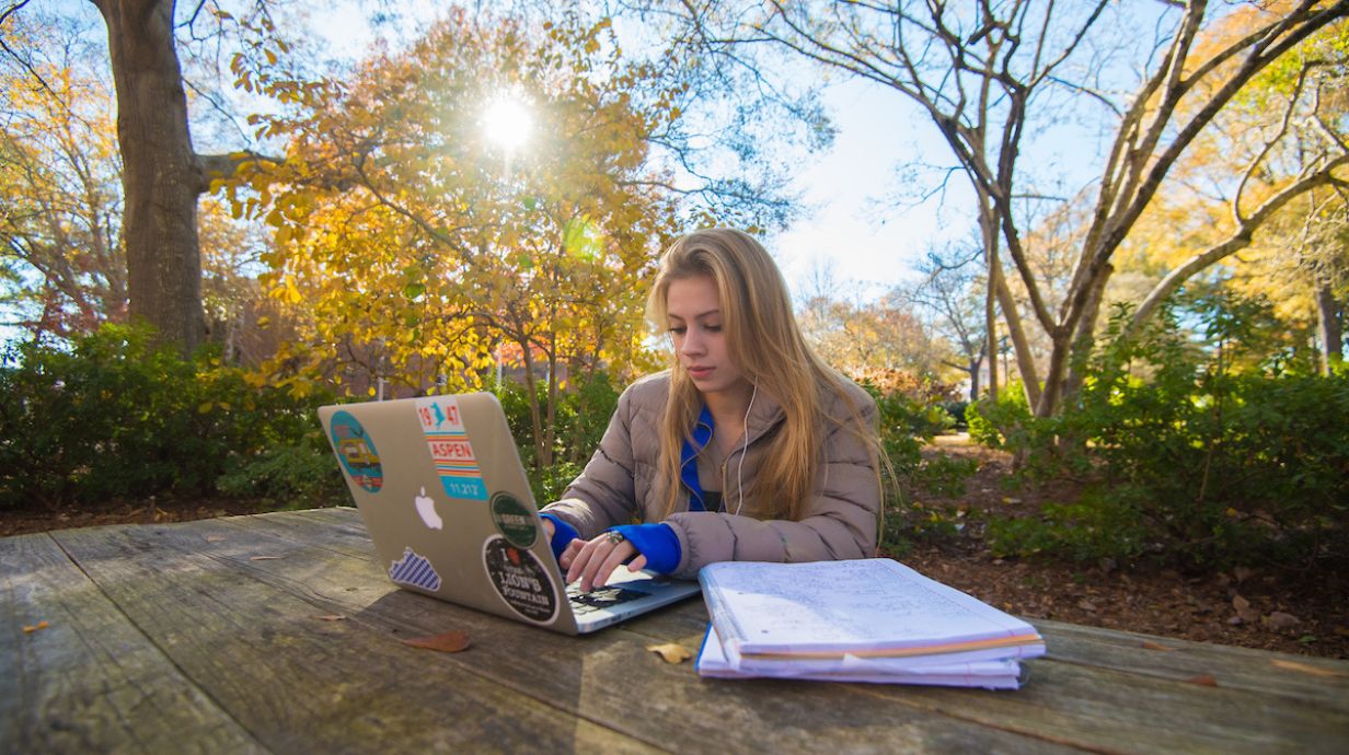 Ph.D. in Health and Kinesiology student studies outside on a crisp autumn afternoon