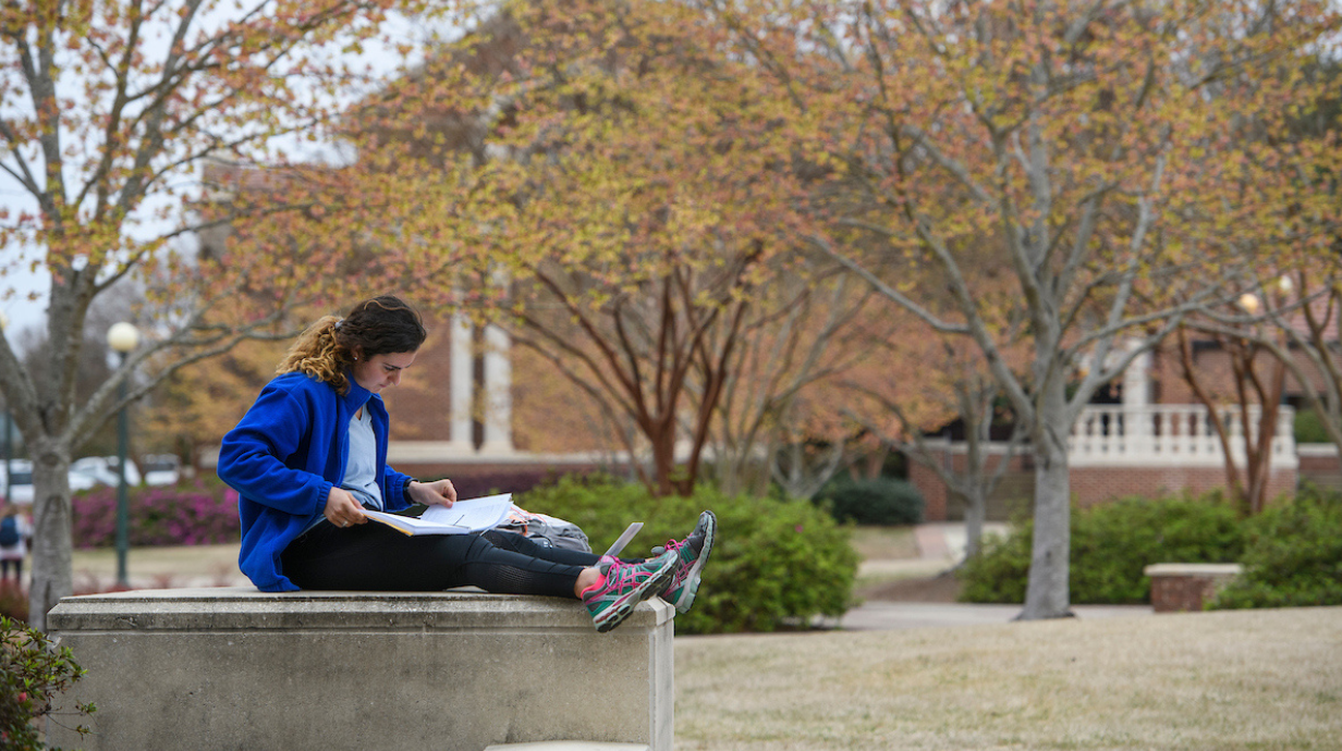 Student studies in the quad. 