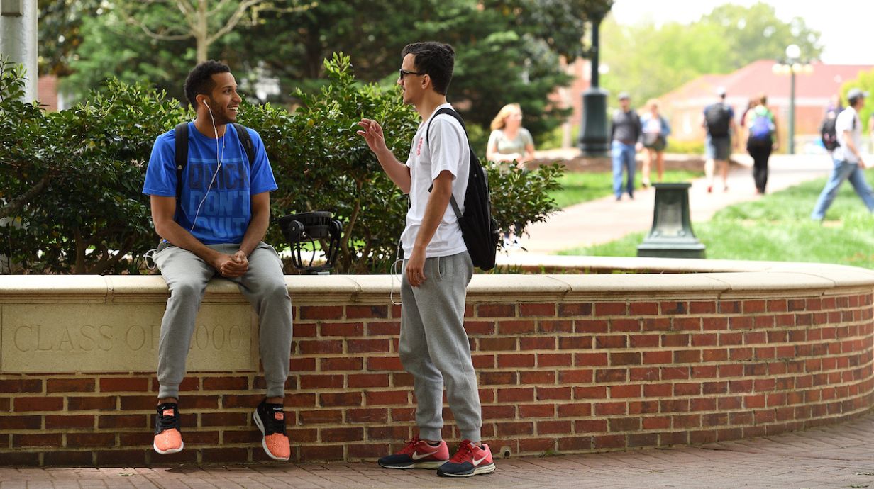 Ph.D. in Social Welfare students talk together on campus.