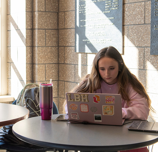 A student studies on her laptop in Conner Hall at Ole Miss