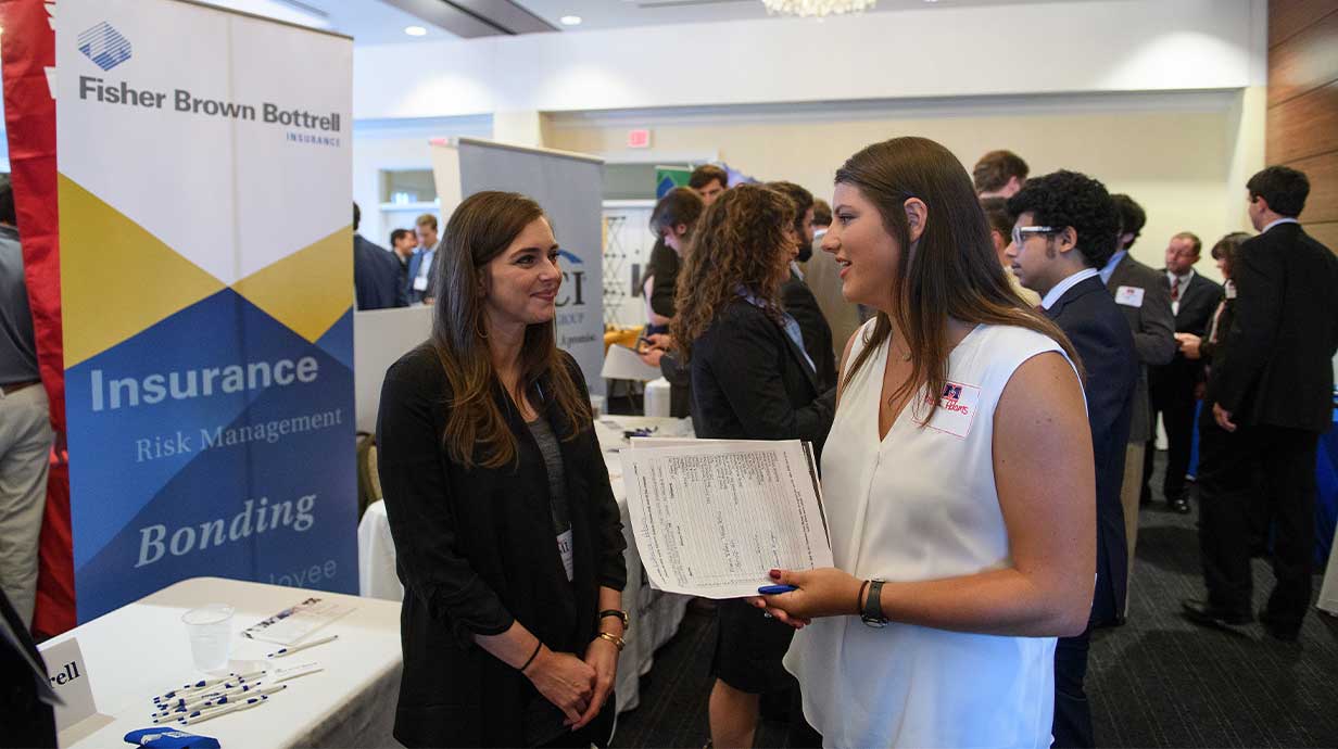 Two female participants converting at the RMI 2017 Fall Career Fair. Photo by Thomas Graning/Ole Miss Communications