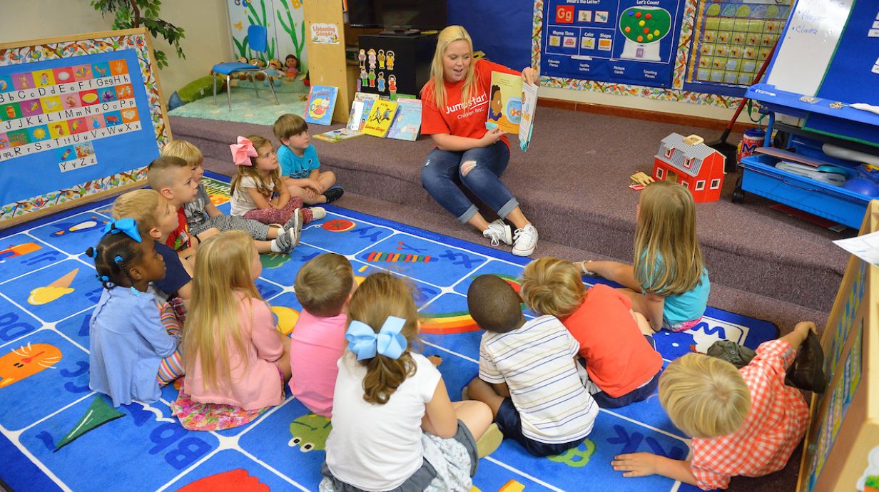 Master of Education (M.Ed.) in Early Childhood Education - teacher reads to students.