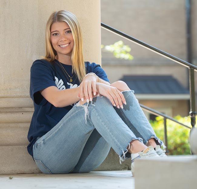 Piper Lind, a biomedical engineering student, poses for a photo out side of Brevard Hall.
