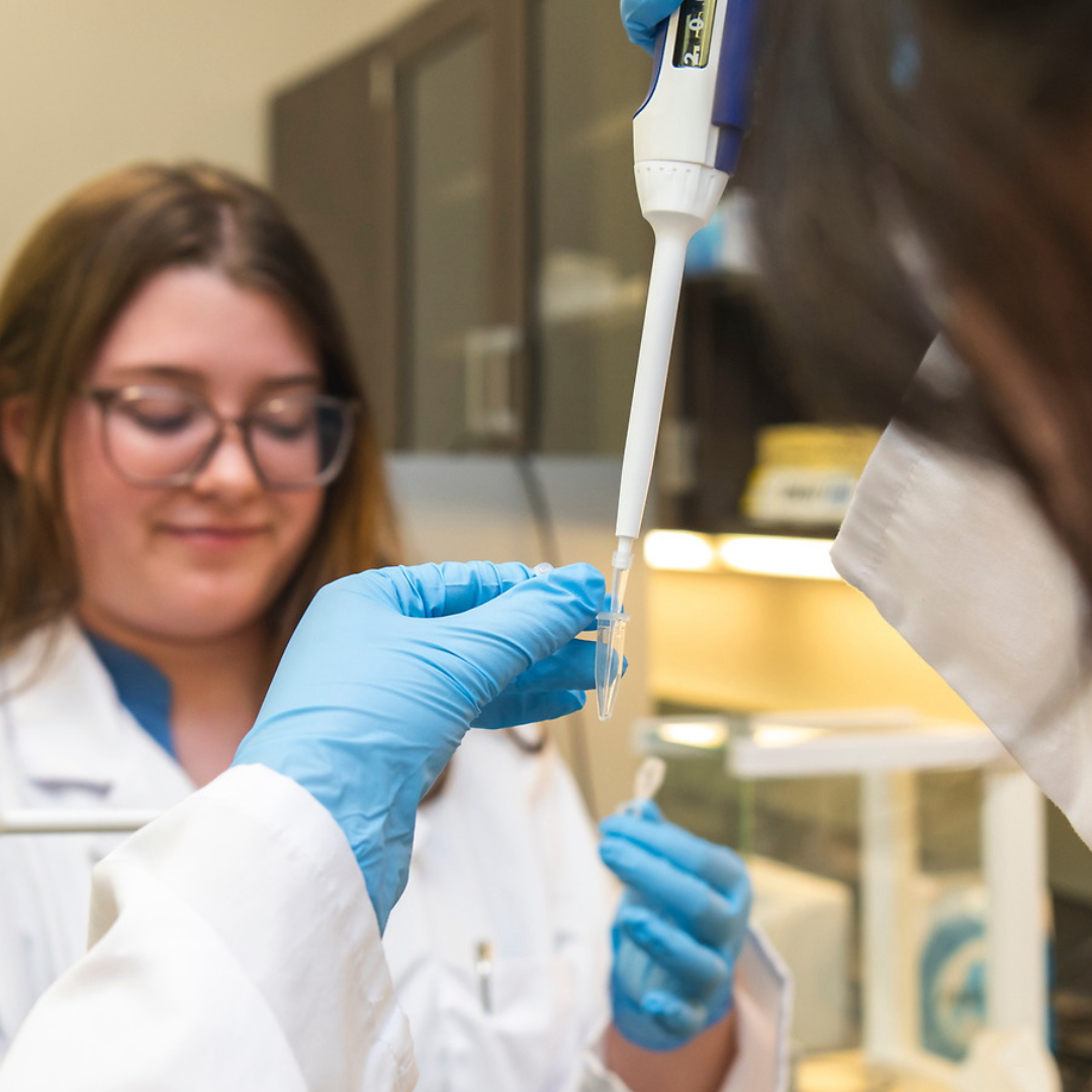 A researcher in a biomedical lab uses a biodevice