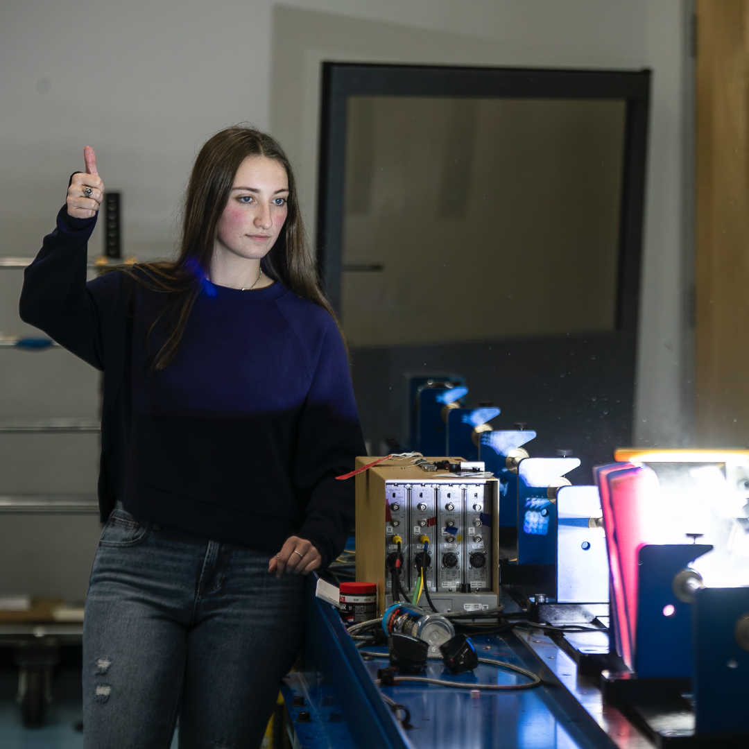 A mechanical engineering student gives a thumbs up in the blast lab