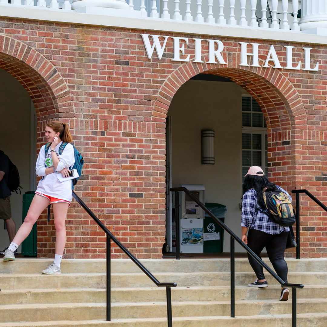 A couple of students walking up the steps of Weir Hall on University of Mississippi's campus