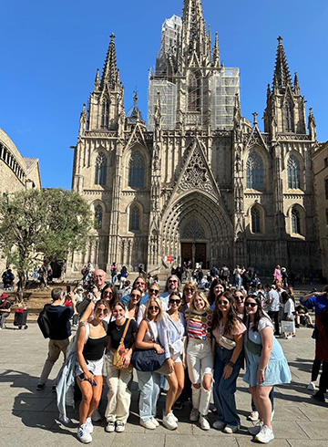 A group of students and professors pose for a photo in Barcelona.