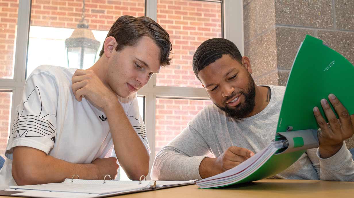 Two students study economics together.