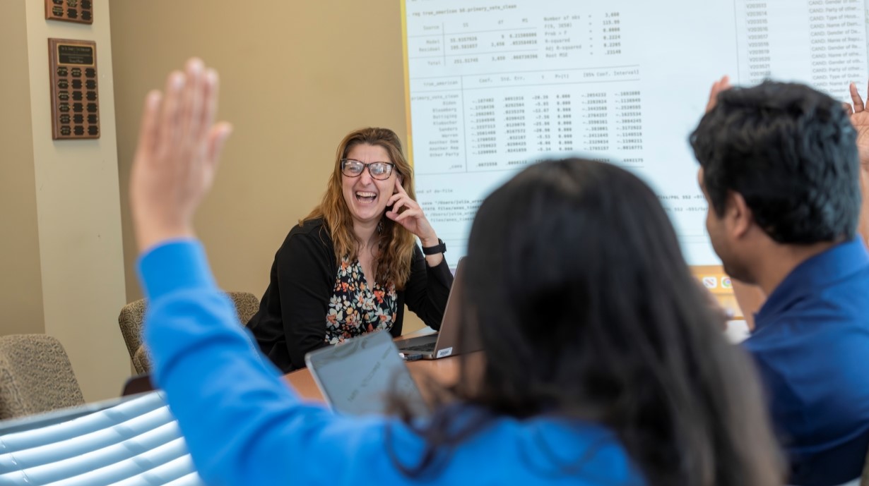 faculty member smiling at students in a class