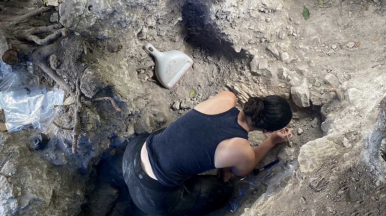 Overhead angle of woman digging in an excavation site