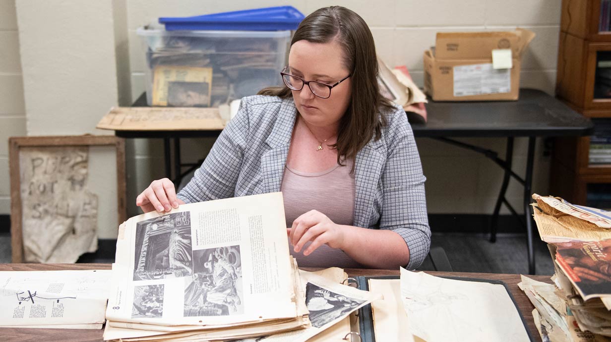 Student at desk looking at primary sources.