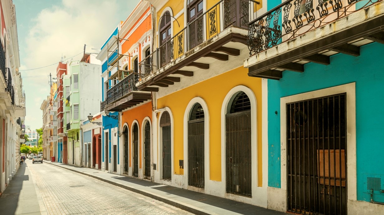 street of colorful colonial-era houses in an urban area of Latin America